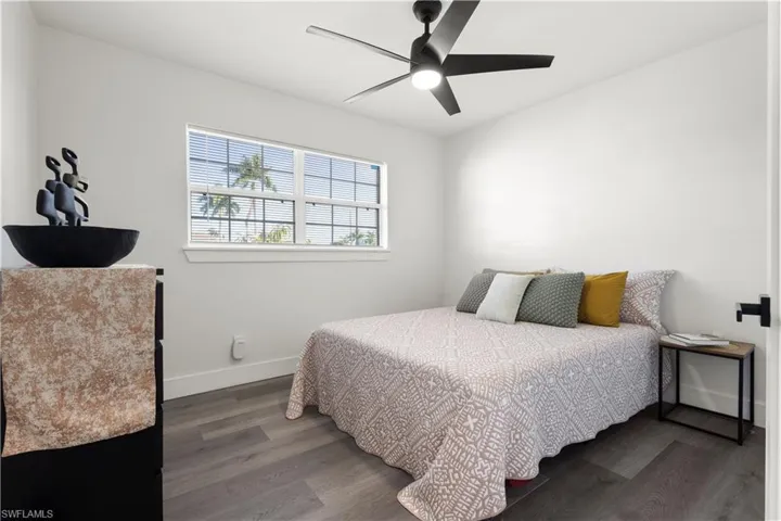 Bedroom featuring ceiling fan and dark hardwood / wood-style flooring