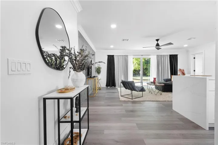 Hallway featuring crown molding and light hardwood / wood-style flooring
