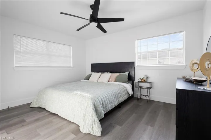 Bedroom with hardwood / wood-style floors and ceiling fan