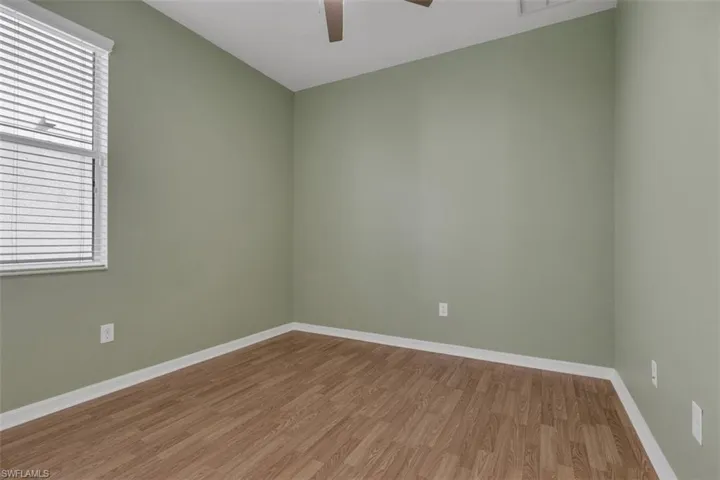 Empty room with light wood-style flooring and ceiling fan