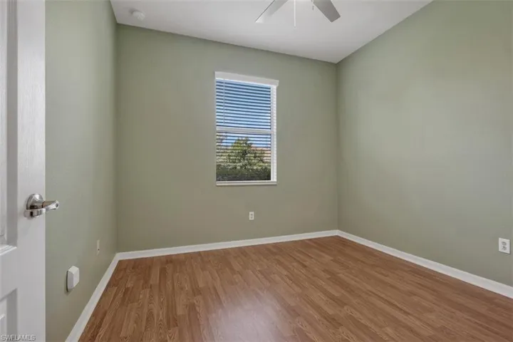 Unfurnished room with wood finished floors and ceiling fan
