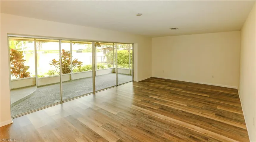 Spacious interior with wood-finish flooring and a neutral color palette