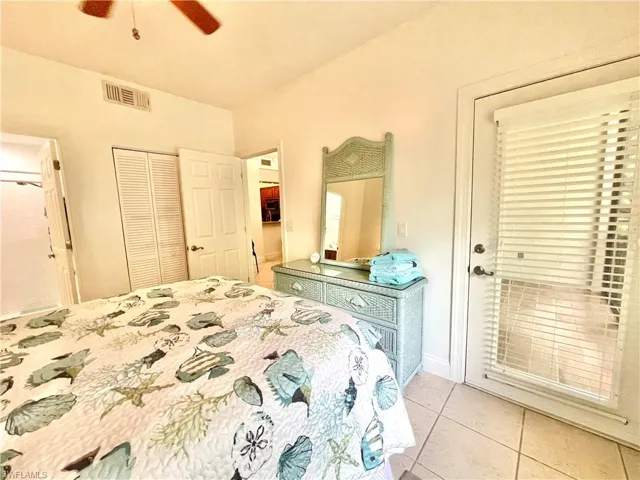 Bedroom featuring light tile patterned flooring, a closet, and ceiling fan