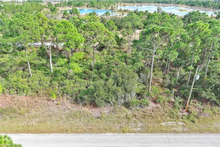 View of tree filled area featuring a water view