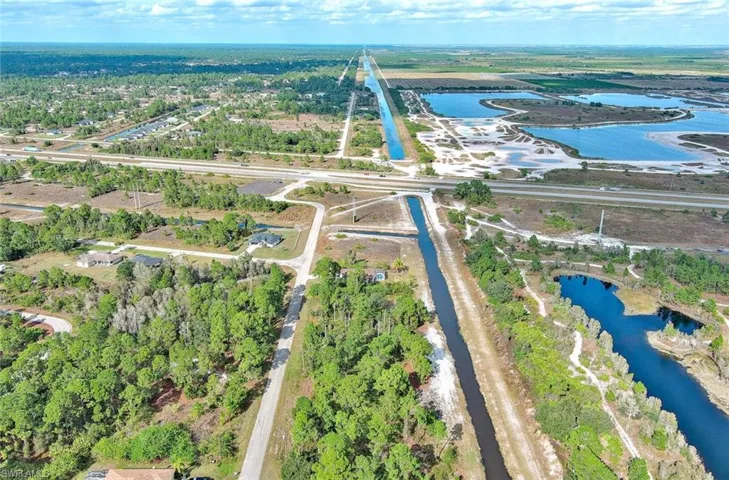 Aerial view of property's location featuring a large body of water