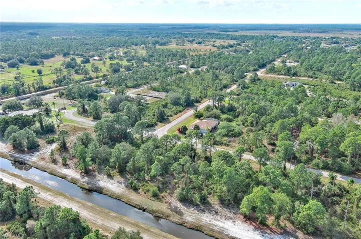 Aerial view of property's location with a large body of water