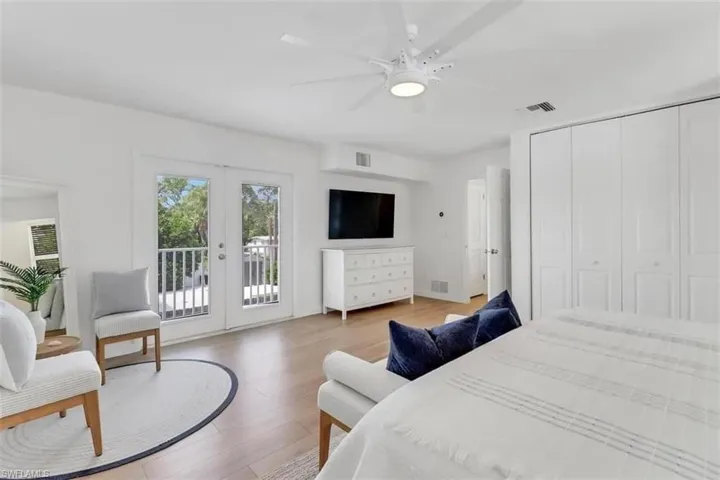 Bedroom featuring access to exterior, french doors, ceiling fan, hardwood / wood-style floors, and a closet