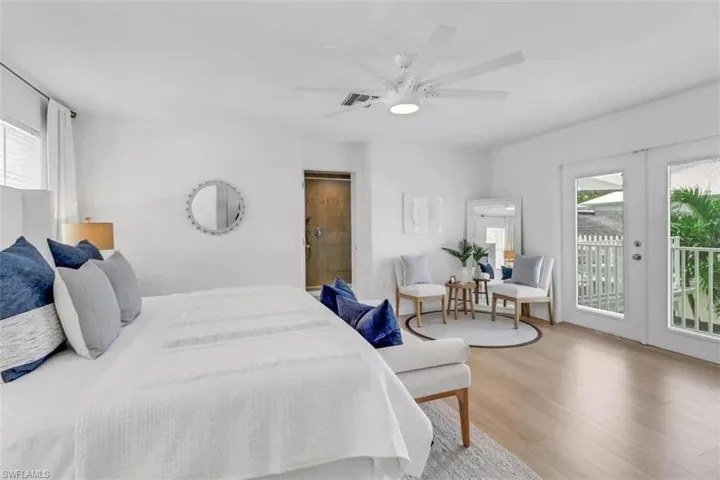 Bedroom featuring ceiling fan, access to exterior, multiple windows, and french doors