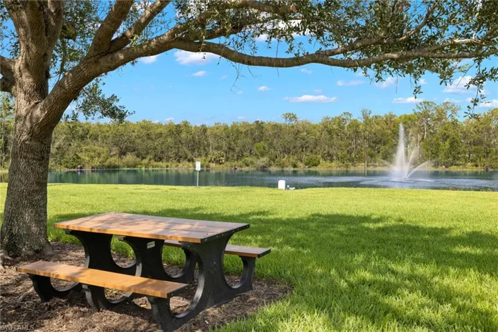 Surrounding community with a water view and a yard