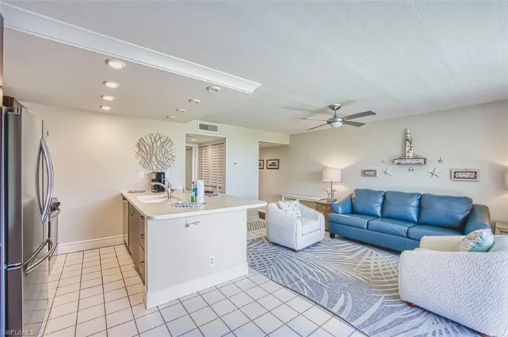 Living room featuring recessed lighting, light tile patterned floors, and ceiling fan