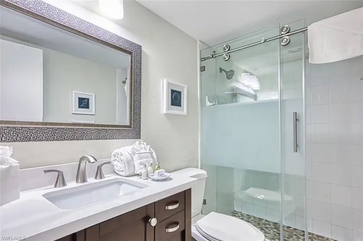 Full bathroom with a shower stall and vanity