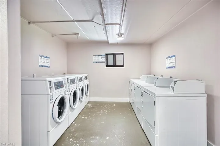 Shared laundry with washing machine and dryer and baseboards