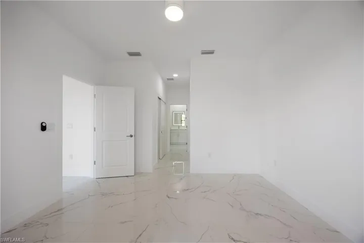 Empty room with light marble finish flooring and baseboards