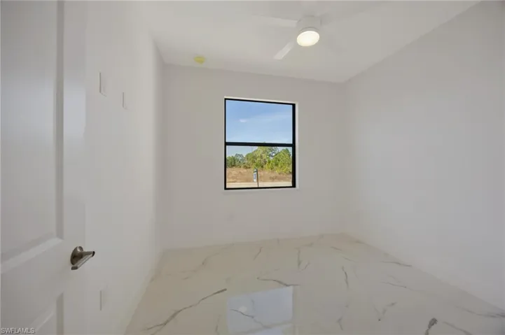 4th bedroom with marble tile finish flooring and a ceiling fan