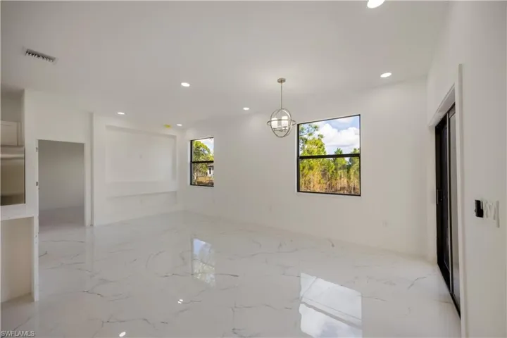 Unfurnished room with recessed lighting and light marble finish floors