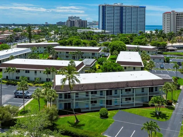 Multi-story buildings featuring white exteriors and brown roofs