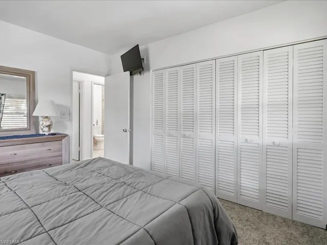 Wall-to-wall louvered closet doors spanning the room's width