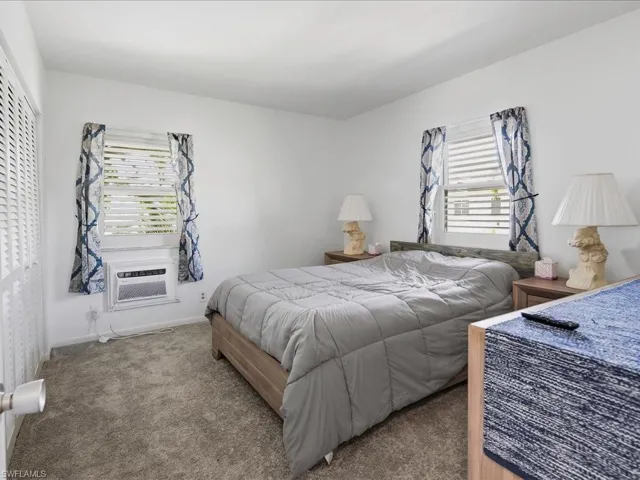 Bedroom featuring neutral carpeting and white painted walls