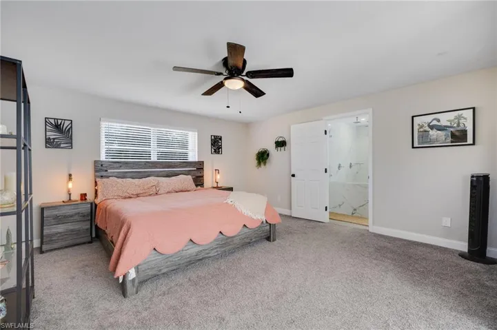 Bedroom featuring carpet, ceiling fan, and connected bathroom