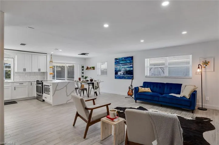 Living room with recessed lighting and light wood-type flooring