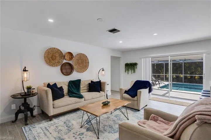 Living area with wood finish floors and recessed lighting