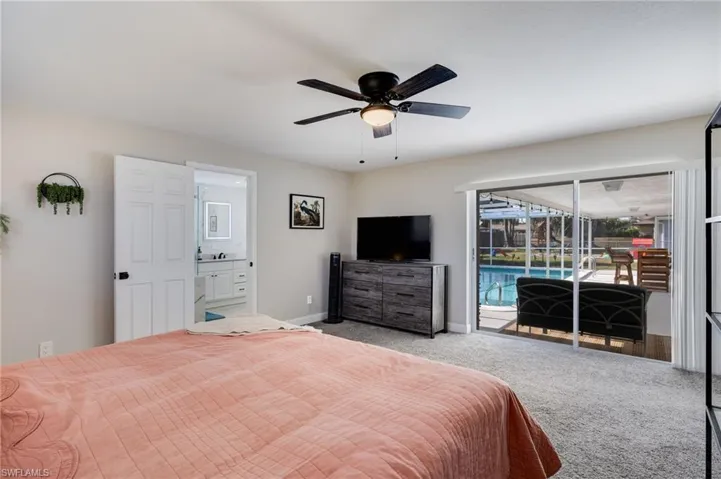 Bedroom with access to outside, carpet floors, a sunroom, and ceiling fan