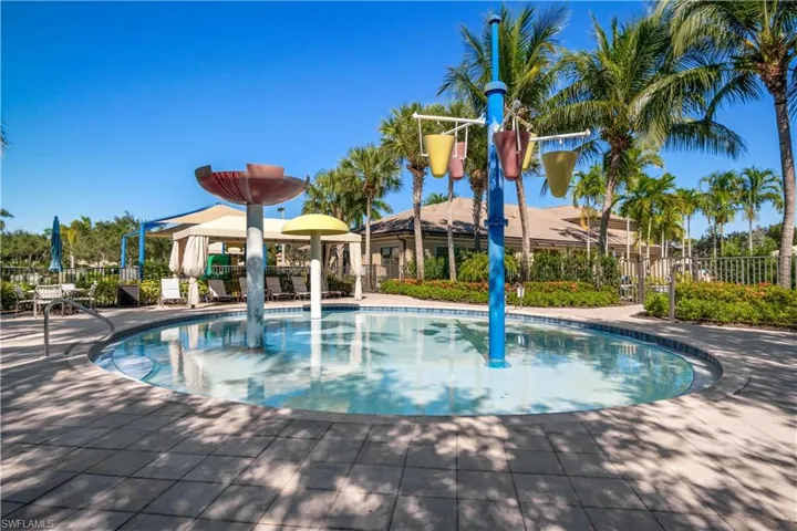 Community pool featuring a water play area
