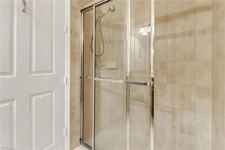 Full bath featuring a shower stall