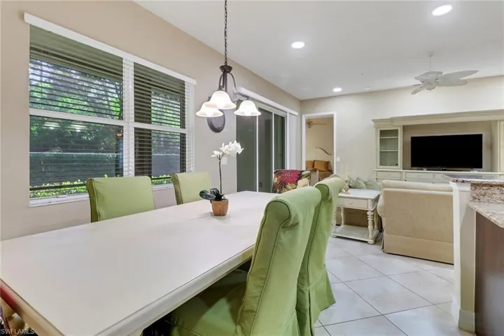 Dining room with a ceiling fan, light tile patterned floors, and recessed lighting