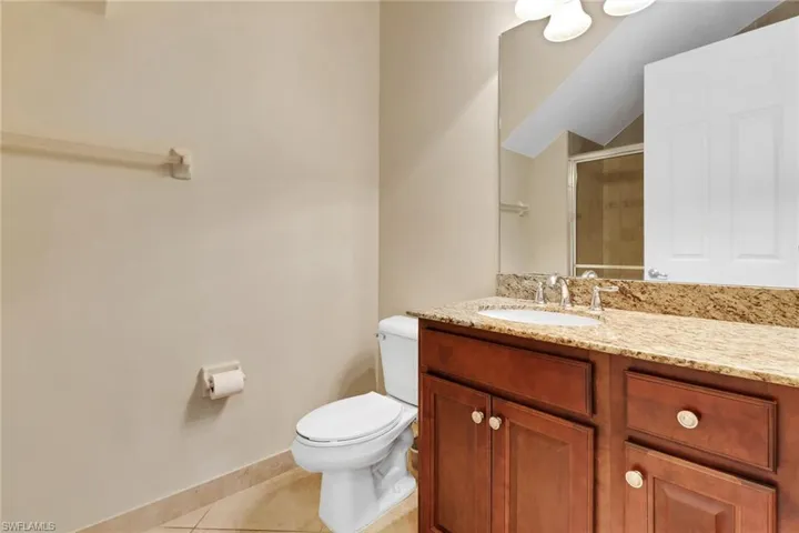 Full bath with vanity, a stall shower, and light tile patterned floors