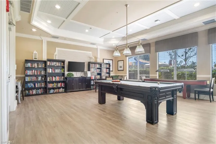 Recreation room with coffered ceiling, pool table, and ornamental molding