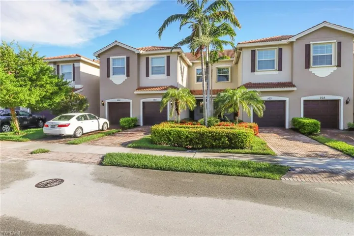 Mediterranean / spanish house featuring stucco siding, a tile roof, an attached garage, and decorative driveway