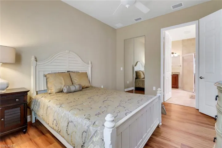 Bedroom featuring light wood-style floors, a closet, and a ceiling fan