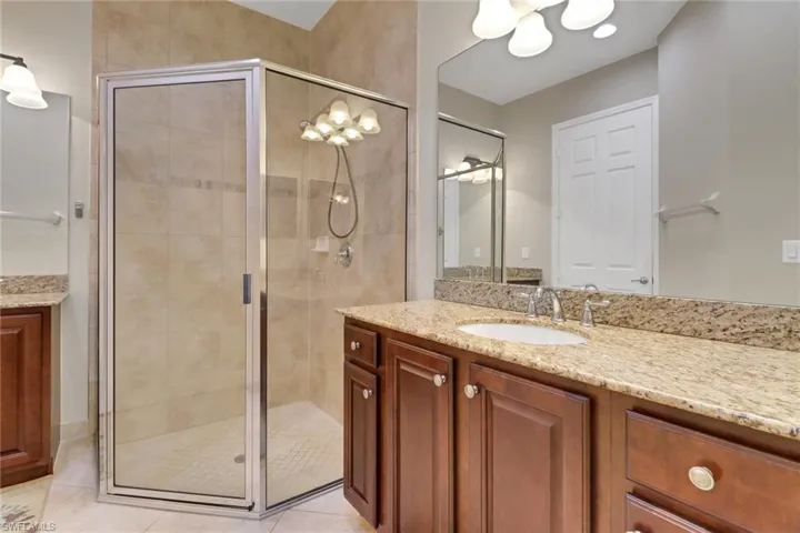 Full bathroom featuring vanity and a shower stall