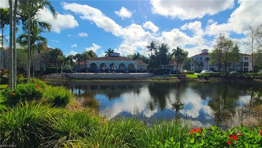 View of community pool and clubhouse across one of the several lakes.