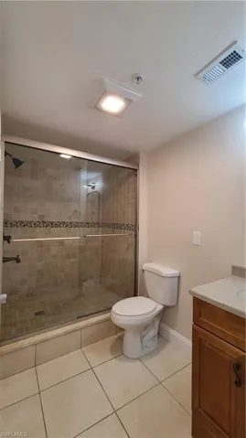 View of the shower with its tempered glass doors.
