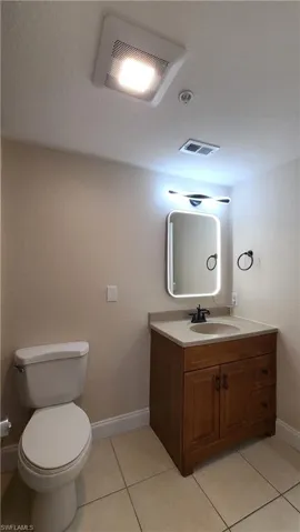 View of bath, vanity, mirror.