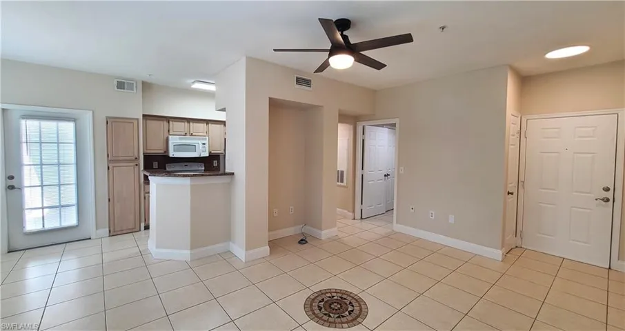 View of living area facing the entry and hallway to bath and bedroom.