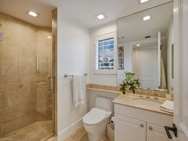 Bathroom featuring a stall shower and vanity