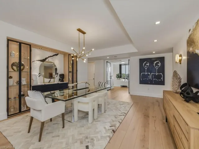 Dining area with light Oak floors and hanging lights