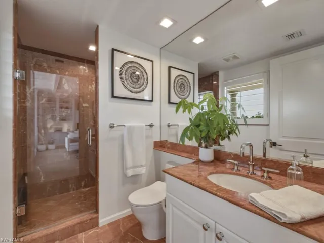 Full bathroom with vanity and a stall shower