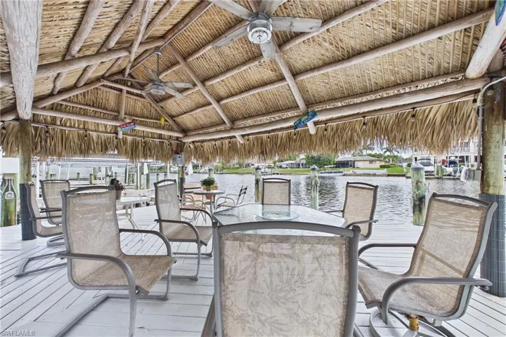 Wooden terrace with ceiling fan and a water view