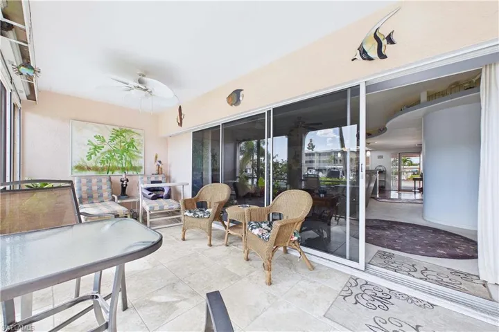 Sunroom with a ceiling fan, a patio area, and an outdoor lounge area