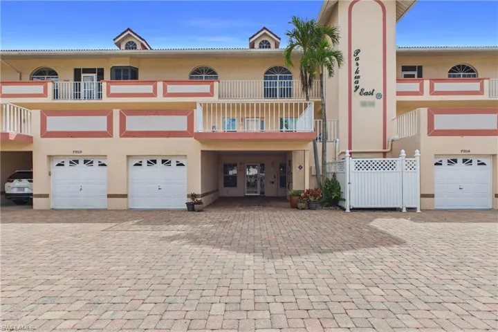 View of front of property with stucco siding and a garage