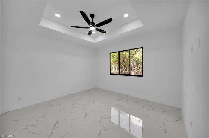Spare room featuring recessed lighting, ceiling fan, and light marble finish floors