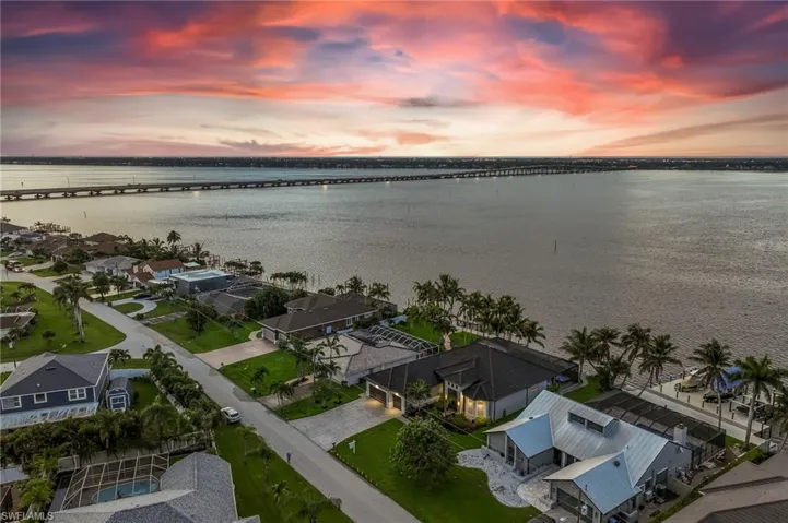Aerial view at dusk of a water view and a residential view