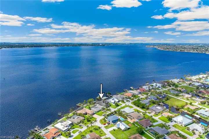 Aerial perspective of suburban area with a large body of water