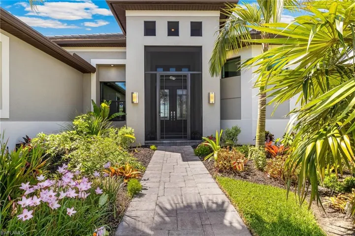 Property entrance with stucco siding and french doors