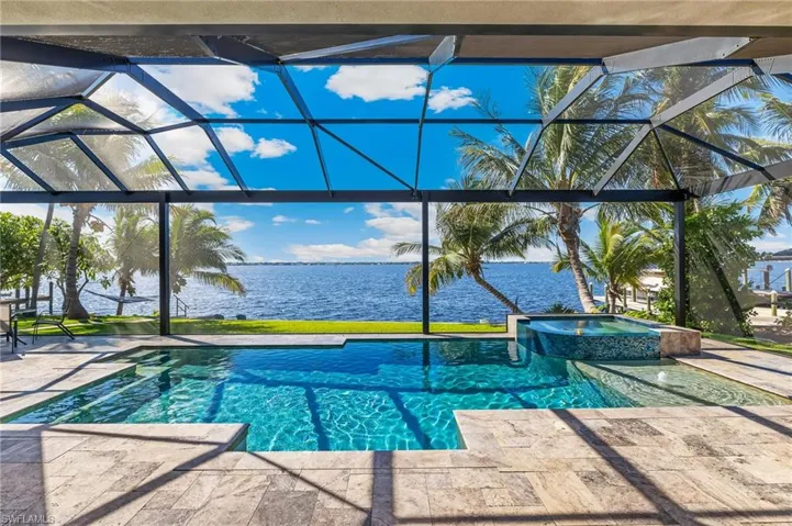 View of pool with a water view, a lanai, and a patio area