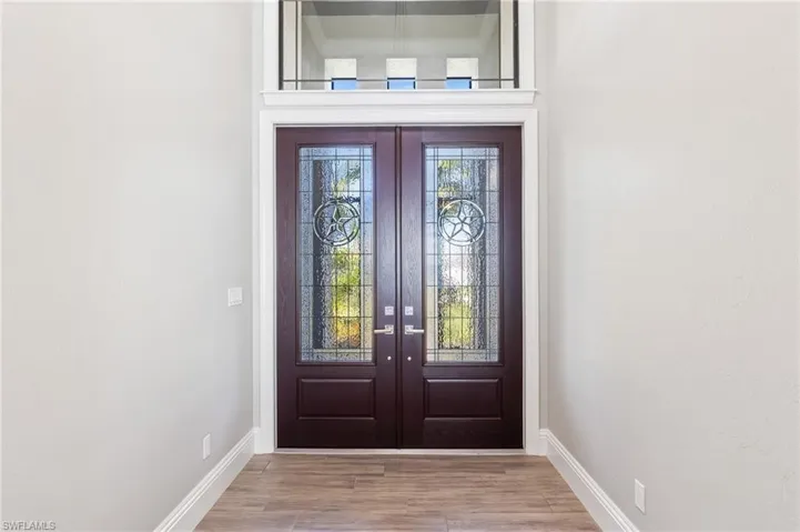 View of exterior entry with french doors and stucco siding